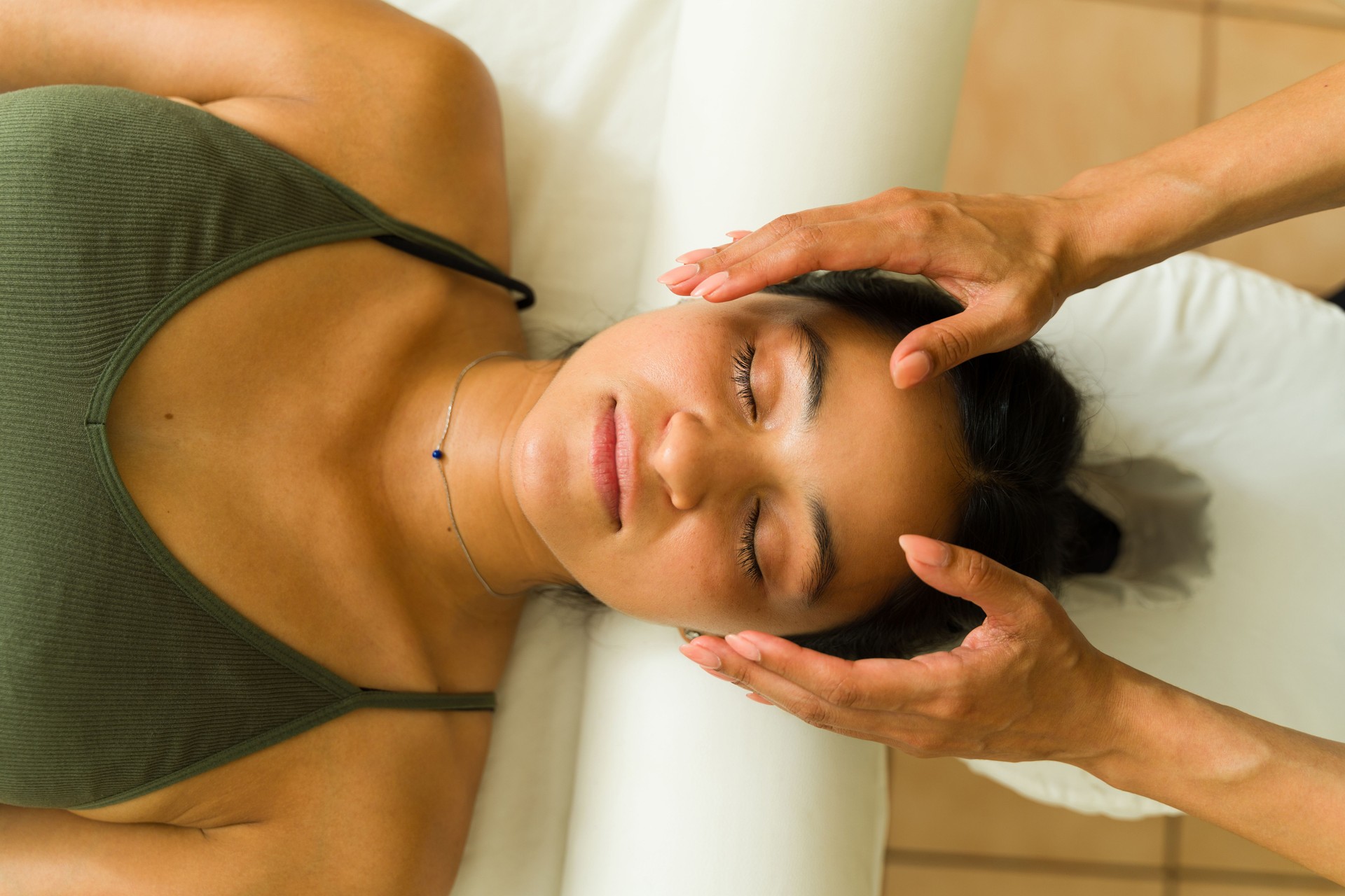 Top view of a relaxing woman getting a head massage